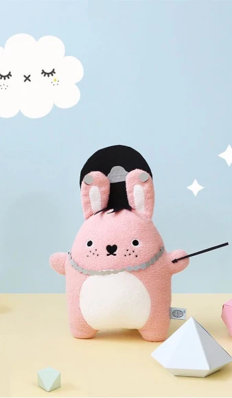 Pink rabbit plush toy in a playful scene