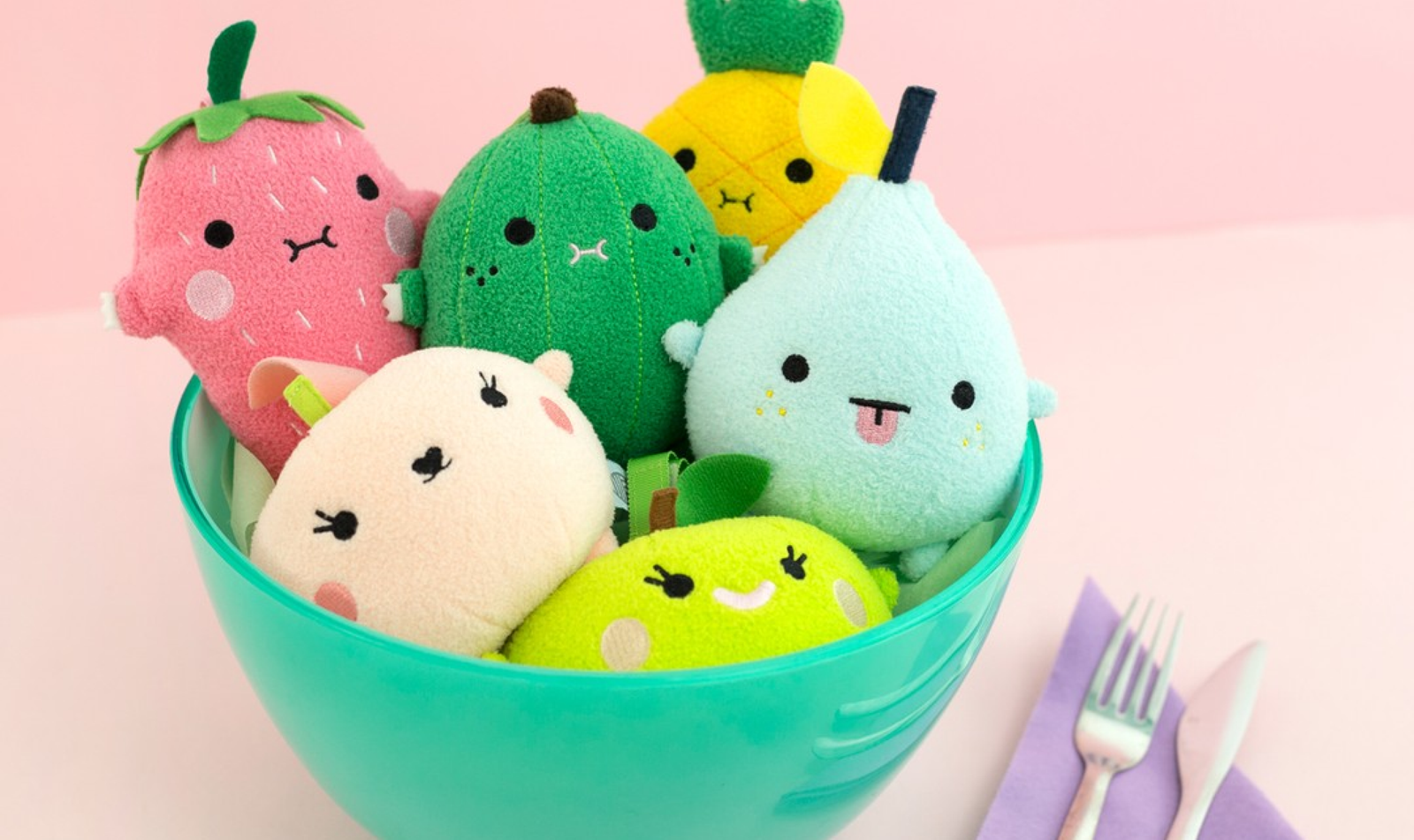 Colorful plush toys gathered in a turquoise bowl